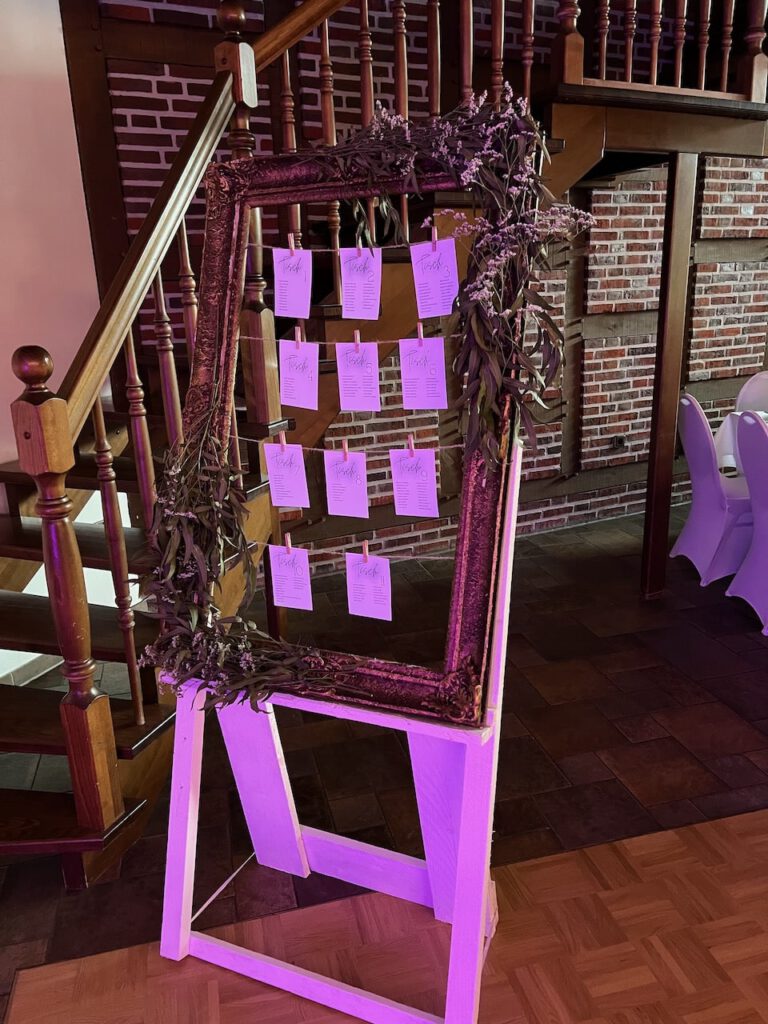 Kreativer Sitzplan im Bilderrahmen mit Kärtchen bei der Hochzeit von Leonie & Lenard