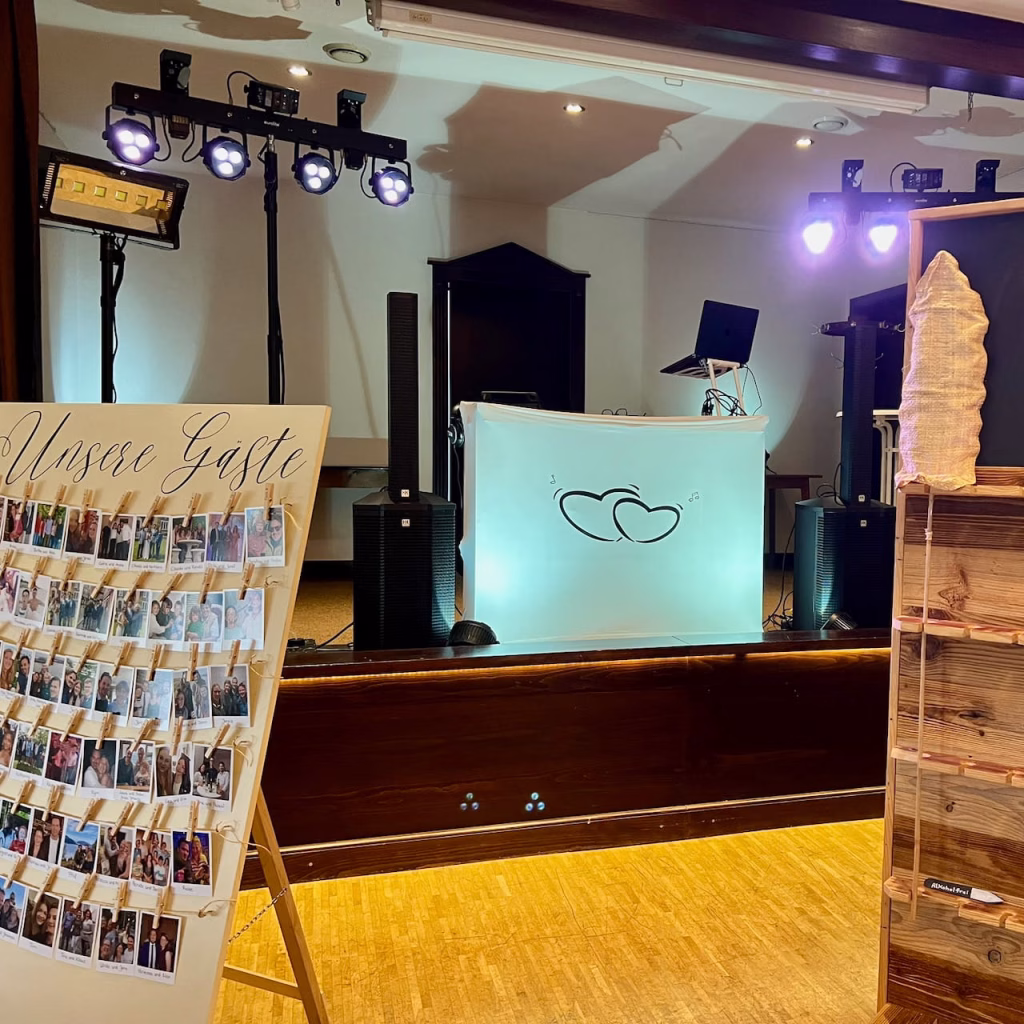 DJ-Setup von DJ Braun4U im Heidekrug Bentstreek – beleuchtetes DJ-Pult mit Herz-Logo und Gästetafel im Vordergrund